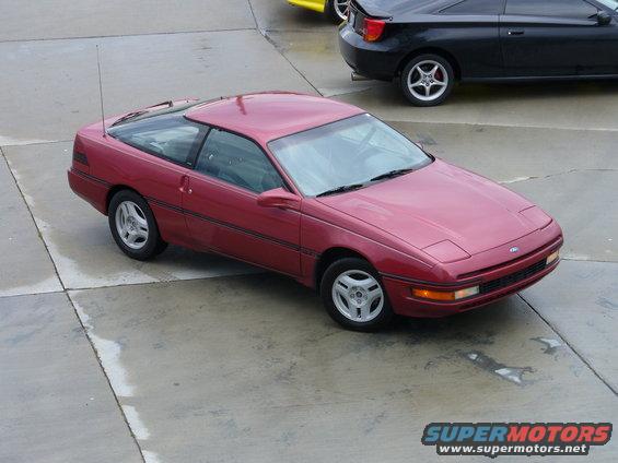 1991 Ford Probe coupe parked on concrete, another car visible behind it