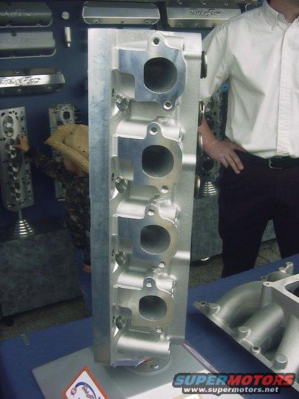 Aluminum engine cylinder head with intake ports, on display table