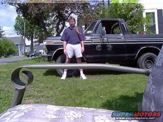 Person standing next to a black Ford Bronco with side trim