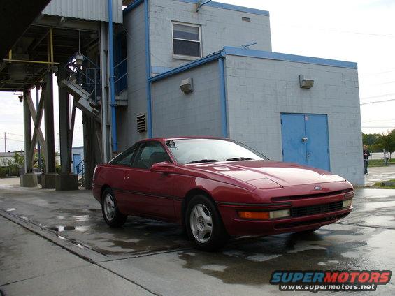 Red 1991 Ford Probe 3q-front view parked on wet concrete