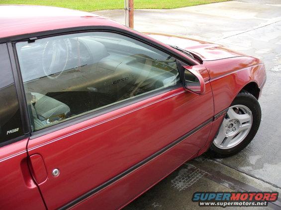 Red coupe side view showing interior and 'PROBE' badge