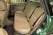 2002 Ford Focus - The interior of a green wagon shows tan leather seats and black seatbelts.