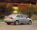 2002 Ford Focus - Rear view of a silver 2002 Ford Focus sedan, showing its taillights and rear bumper. The vehicle is parked on a street in front of a buildi…
