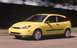 2002 Ford Focus - This yellow 2002 Ford Focus hatchback is shown from a three-quarter front view while driving.