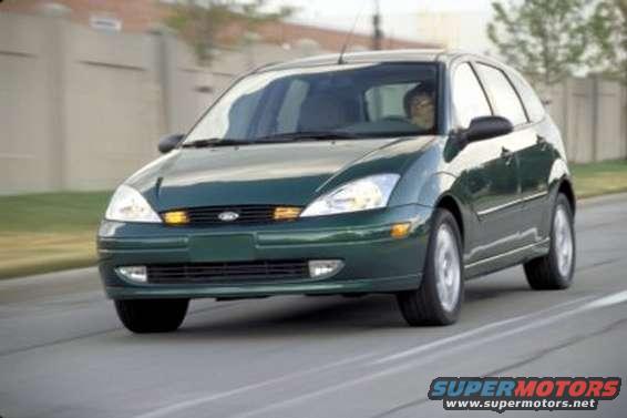 Green 2002 Ford Focus hatchback driving on a road
