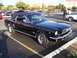 2002 Ford Mustang - This black 1965 Ford Mustang coupe features a black vinyl top and chrome accents.