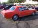2002 Ford Mustang - This classic orange coupe is a 1965 Ford Mustang, not a 2002 model.