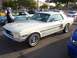 2002 Ford Mustang - A white 1967 Ford Mustang coupe with distinctive blue side stripes is parked at an outdoor event.