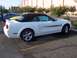 2002 Ford Mustang - A white convertible Ford Mustang GT/CS is parked in a lot with other vehicles.