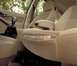 2002 Ford Focus - The interior of a 2002 Ford Focus shows the driver's seat, center console, and armrest with a map in the seat pocket.