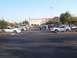 2002 Ford Mustang - A group of Ford Mustangs are gathered in a parking lot on a clear day.
