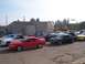 2002 Ford Mustang - Several Ford Mustangs, including a red coupe and a black coupe, are parked together outdoors.