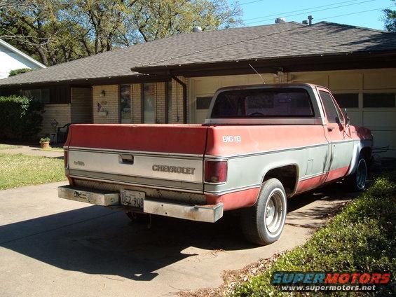 Rear view of a red and gray Chevrolet C10 pickup truck, circa 1980