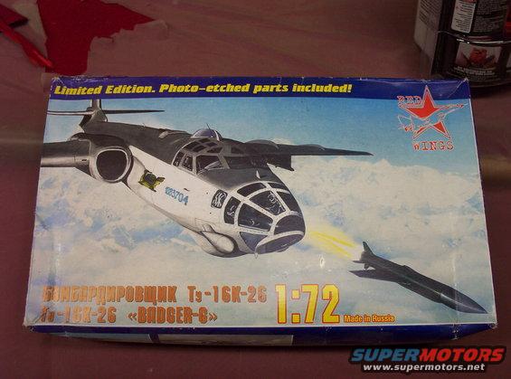 Model airplane box art depicting a bomber launching a missile, with text in Russian and English