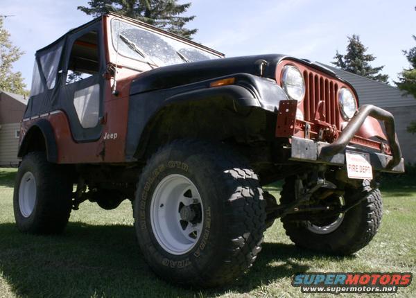 Red and black Jeep CJ5 with soft top and "FIRE DEPT" plate