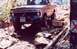 1976 Ford F-100 - A red Ford F-100 navigates a rocky trail, with another vehicle visible in the background.