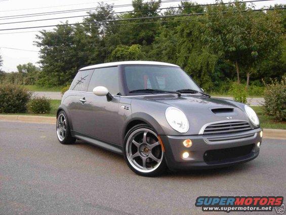 Gray 2003 MINI Cooper S with white roof and aftermarket wheels parked on asphalt