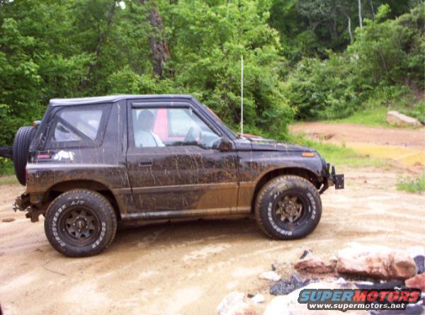 Mud-covered 1996 Chevrolet Tracker 4x4 with a spare tire on the back, seen from the side