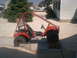 2003 Yamaha RAPTOR 660 - A red three-wheeled ATV, identified as an Odyssey, is parked outdoors on a gravel surface.