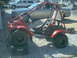 2003 Yamaha RAPTOR 660 - A red three-wheeled ATV, labeled 'ODYSSEY', is parked on a gravel surface.