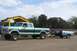 1994 Ford F-150 - A two-tone 1977 Ford F-Series truck tows a trailer carrying a disassembled truck bed.
