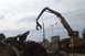 1994 Ford F-150 - A demolition crane operates over a scrap yard, with a ship visible in the distance.