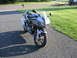 2006 Suzuki SV1000S - Silver 2006 Suzuki SV1000S motorcycle is parked on a gravel driveway with a grassy lawn in the background.