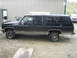 1990 Chevrolet Suburban - This 1990 Chevrolet Suburban is seen from the side, chrome trim and Dayton tires.