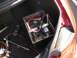 1998 Mercury Sable - Tools and a car battery are visible inside the trunk of a red vehicle.