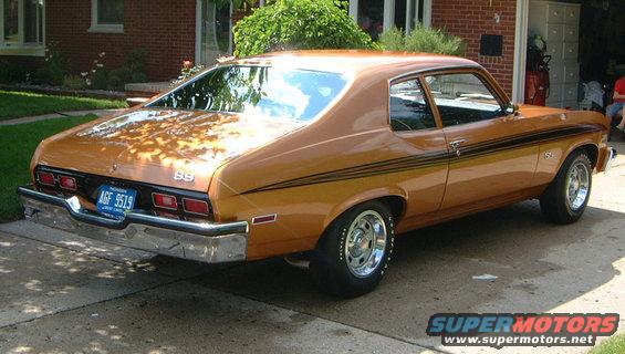 Rear quarter view of a 1973 Chevrolet Nova SS. It has a brown paint job with black racing stripes and chrome wheels