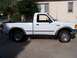 1994 Ford Ranger - This white Ford Ranger pickup truck is shown from the side, parked in front of a house.