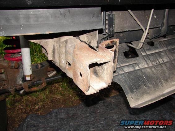 Rusty tow hook bracket on vehicle undercarriage