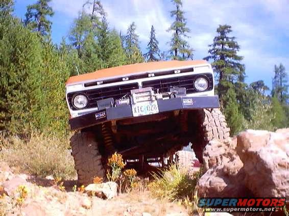 1976 Ford F-100 front view, climbing over rocks on a trail