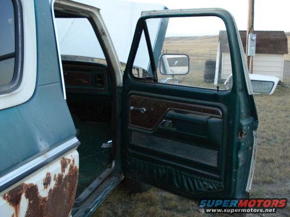 1979 Ford Bronco interior showing the driver's side door panel and dashboard