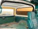 1979 Ford Bronco - The interior of a 1978 Ford Bronco shows green upholstery and a view of a rural landscape through the windows.