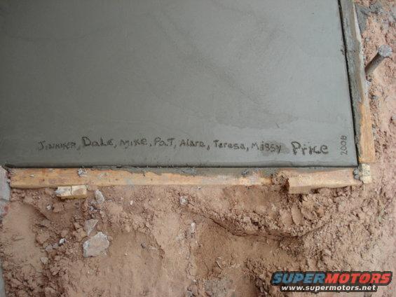 Names and '2008' written in wet concrete, with wooden forms