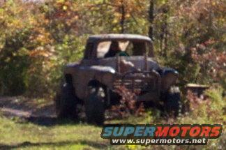 Off-road vehicle with large tires in a wooded area