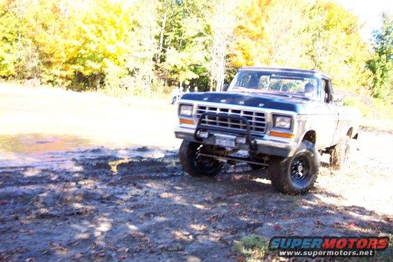 Ford pickup truck with bull bar in muddy terrain