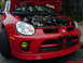 2005 Dodge SRT-4 - Front view of a red 2005 Dodge SRT-4 with the hood open, revealing the engine.