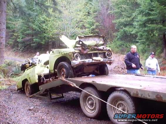 Wrecked 1976 Ford F-100 on flatbed trailer, front view