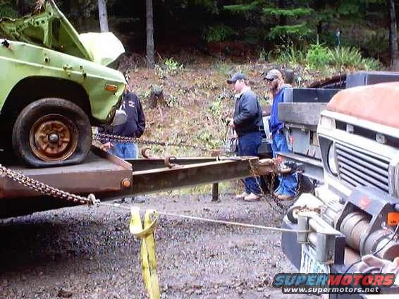 1976 Ford F-100 on a trailer next to another truck