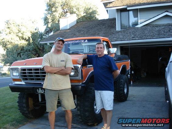 Orange lifted 1979 Ford truck with two men standing in front