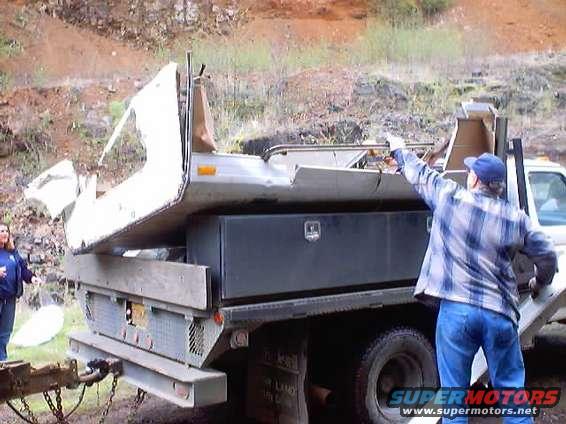 Truck bed with camper shell being loaded, rear view