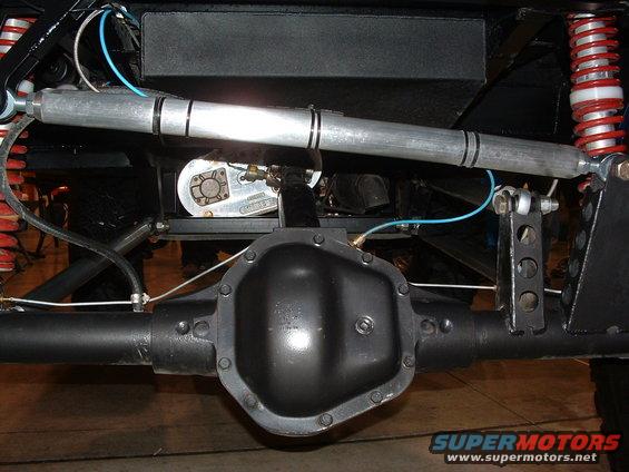 Rear axle assembly with red coilover shocks and silver steering stabilizer