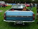 1970 Ford Ranchero - Rear view of a blue 1970 Ford Ranchero pickup truck parked on grass with other vehicles in the background.