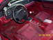 1990 Ford Mustang - The interior of a 1990 Ford Mustang shows a manual shifter and aftermarket gauges.