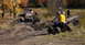 1979 Ford Bronco - ATV riders observe off-road vehicles navigating a challenging muddy terrain during an outdoor excursion.