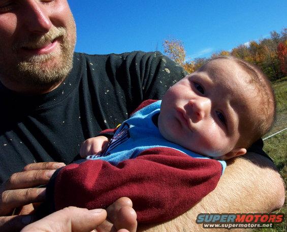 Baby held by man outdoors