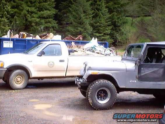 Silver Jeep CJ-7 with black interior and off-road tires