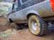1976 Ford F-100 - This 1976 Ford F-100 navigates a muddy off-road trail, its tires caked with dirt.